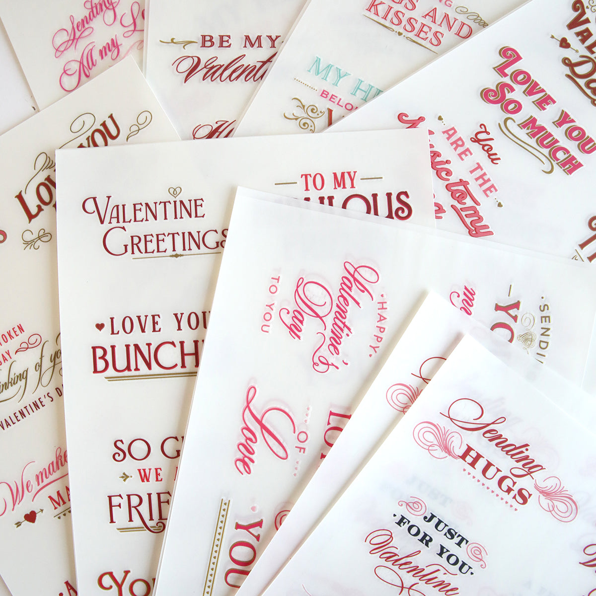 Discover the "Smitten Sentiments Rub On Transfers," an array of Valentine's Day messages adorned with phrases such as "Be My Valentine" and "Love You So Much" in captivating red and pink fonts. These transfers are beautifully embellished, creating the perfect touch for your special someone.