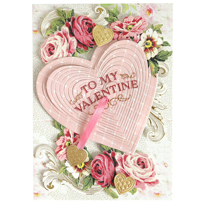 A Valentine's Day card utilizing Smitten Sentiments Rub On Transfers, showcasing a pink heart design with floral patterns and gold heart embellishments, labeled "To My Valentine.