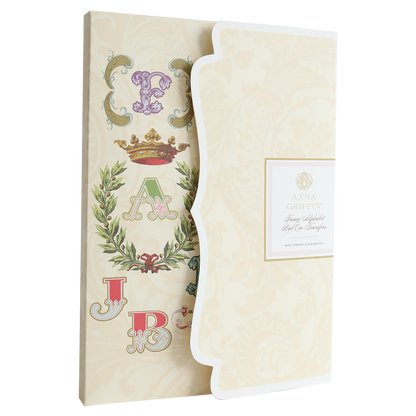A decorative stationery set ideal for scrapbooking and cardmaking, featuring a cover with letters, crown, laurel motifs, and labeled "Fancy Alphabet Rub On Transfers.