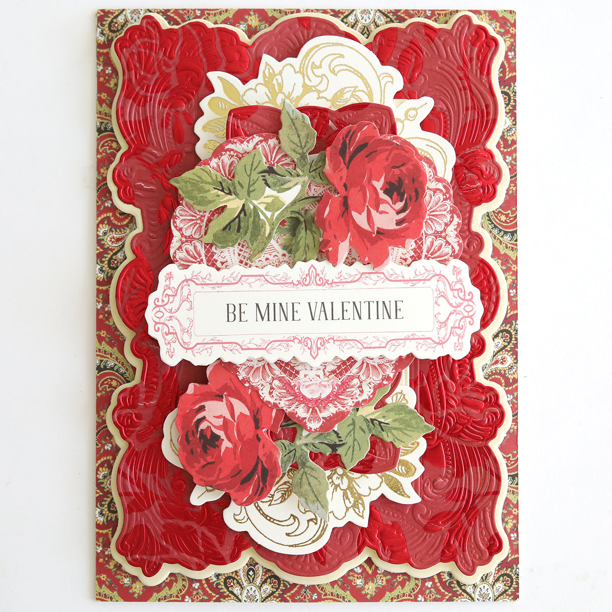 Ornate Valentine’s Day card made from Luxury Tonal Foil Heartfelt Cardstock, featuring red and gold layered patterns, embossed rose details, green leaves, and a central “Be Mine Valentine” message.