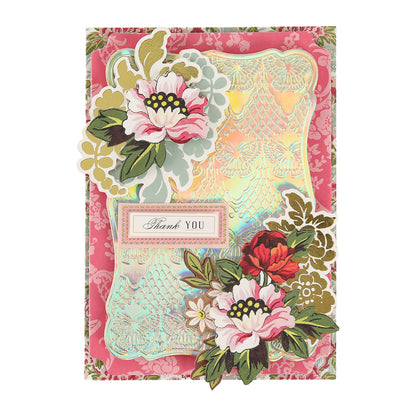A luxurious thank you card crafted from Luxury Iridescent Foil Cardstock, featuring elegant floral designs and shimmering gold accents with a “Thank You” label at the center. Set against a pink patterned background, this high-quality card showcases both sophistication and durability—perfect for expressing your heartfelt gratitude.