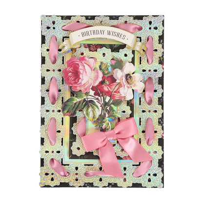 A decorative birthday card features floral artwork, gold trim, pink ribbon accents, and a banner reading “Birthday Wishes” at the top, all beautifully crafted on Luxury Iridescent Foil Cardstock for an elegant touch.