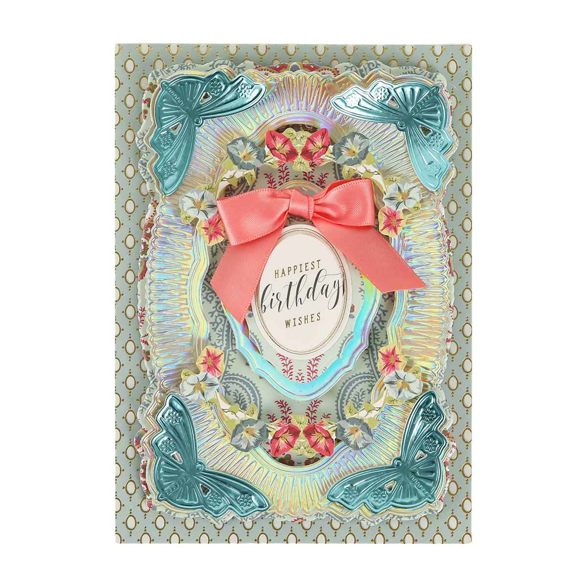 This decorative birthday card is crafted from Luxury Iridescent Foil Cardstock, and features embossed teal butterflies, elegant floral patterns, a delicate pink bow, and an oval label in the center that reads “Happiest birthday wishes.”.