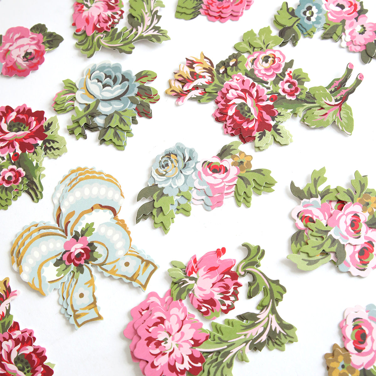 Phoebe Die Cut Embellishments feature colorful, vintage-style floral paper cutouts scattered on a white background, ideal for use as stickers or scrapbook decorations.