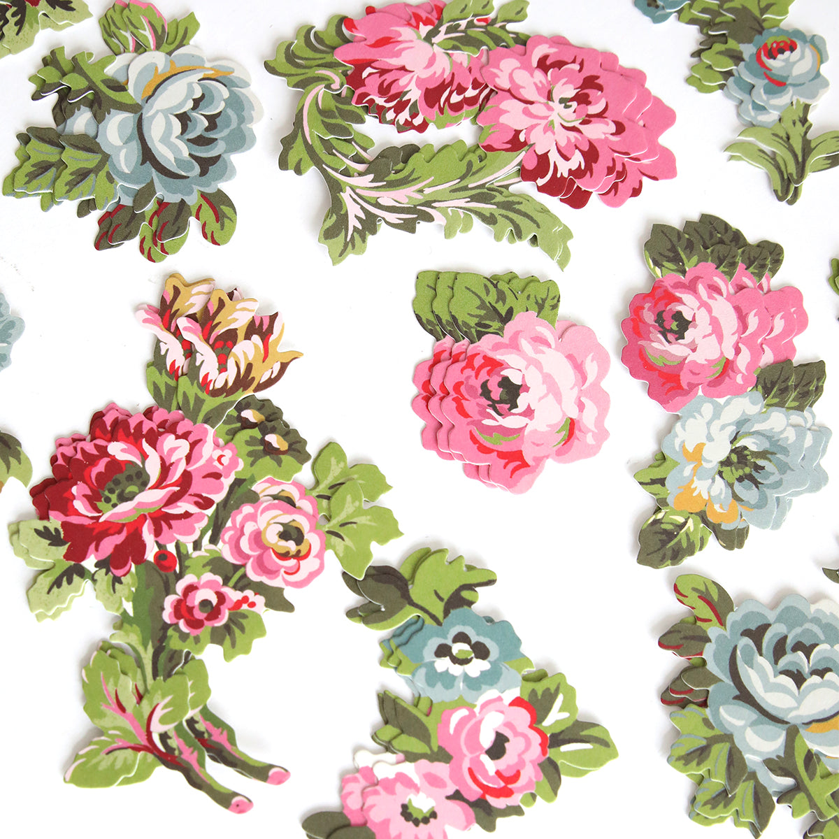 Add a vintage touch to your scrapbook with Phoebe Die Cut Embellishments—colorful paper cutouts featuring pink, red, and blue florals with green leaves on white backgrounds.