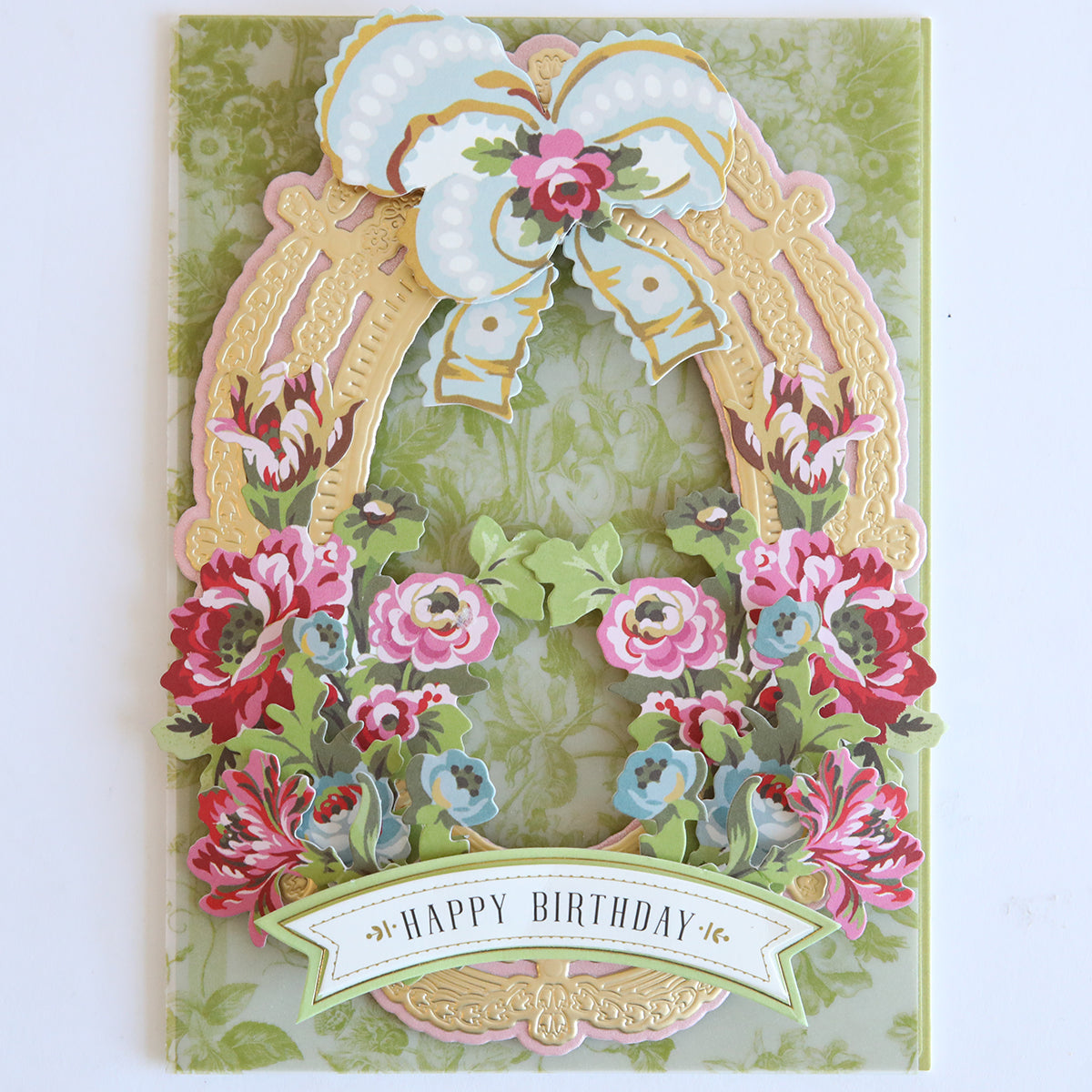 A decorative birthday card with a pastel bow, gold frame, and pink-red flowers plus “Happy Birthday” banner—perfect for pairing with Phoebe Die Cut Embellishments.