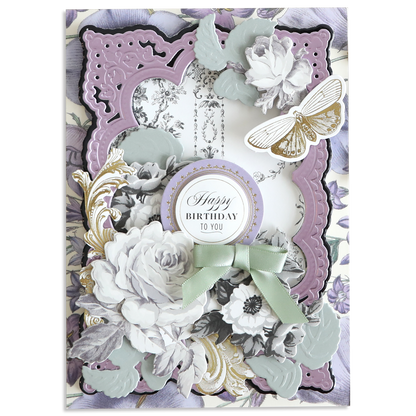 Decorative birthday card featuring Faded Rose Die Cut Embellishments, layered vintage florals, a gold and white butterfly, a round "Happy Birthday to You" message, craft accents, and a green ribbon bow at the center.