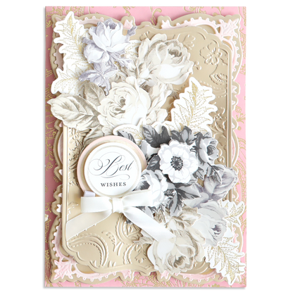 The Faded Rose Die Cut Embellishments feature vintage florals, embossed gold accents, layered white and grey designs, a white ribbon, and a "Best Wishes" tag—ideal for craft lovers seeking a decorative touch.