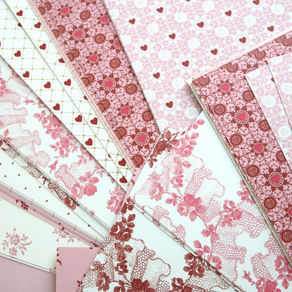 Heartfelt Cardstock: Elegant pink and white scrapbook paper featuring floral designs, hearts, and lace motifs in an overlapping layout.