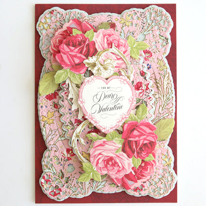 The Heartfelt Cardstock is a decorative Valentine’s Day card with pink and red roses, ornate floral scrapbook patterns, and a heart-shaped tag that reads "For my Dear Valentine.
