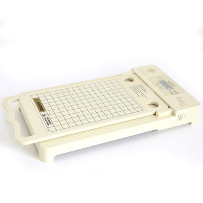 A cream-colored Empress Gild hot Foil Machine featuring a grid surface, handle, control buttons, and a digital display on one side; includes holiday hot foil.