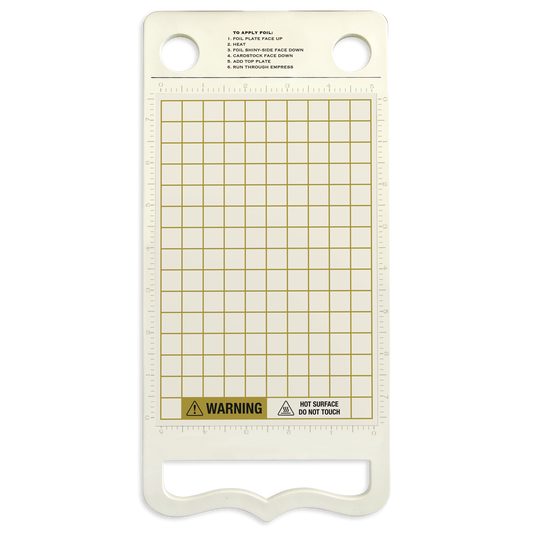 The Empress Gild Heat Platform is a clear rectangular platen with a grid, top instructions, two large holes, and a "Hot Surface, Do Not Touch" warning label—perfect for foil machines or die cutting projects.