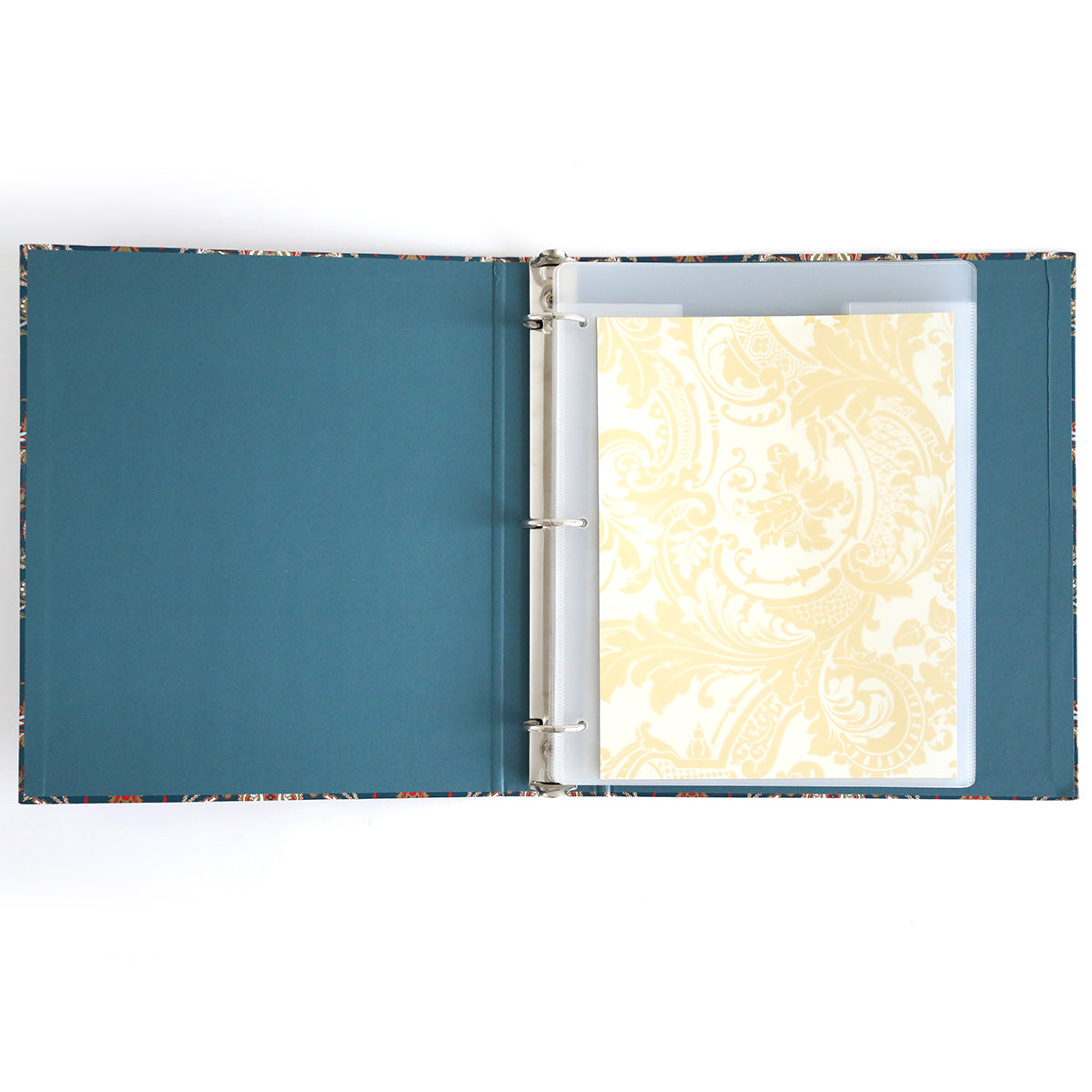 The Jasmine Die Storage Binder features blue inner covers and displays a decorative cream sheet in a plastic sleeve, making it ideal for craft organization or as a magnetic die storage binder for cutting dies.
