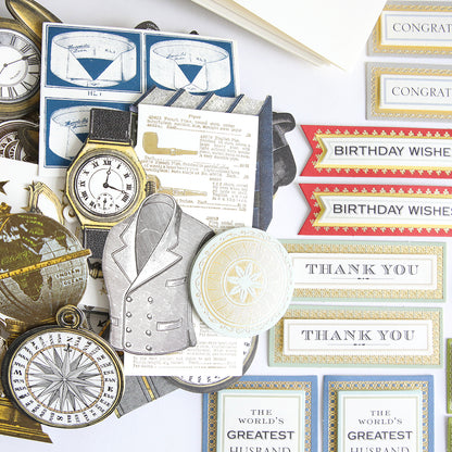 Assorted vintage-style paper cutouts from the All About Him Papercrafting Kit with Dies, featuring watches, compasses, suit jackets, and message cards like "THANK YOU" and "BIRTHDAY WISHES," displayed on a white background.