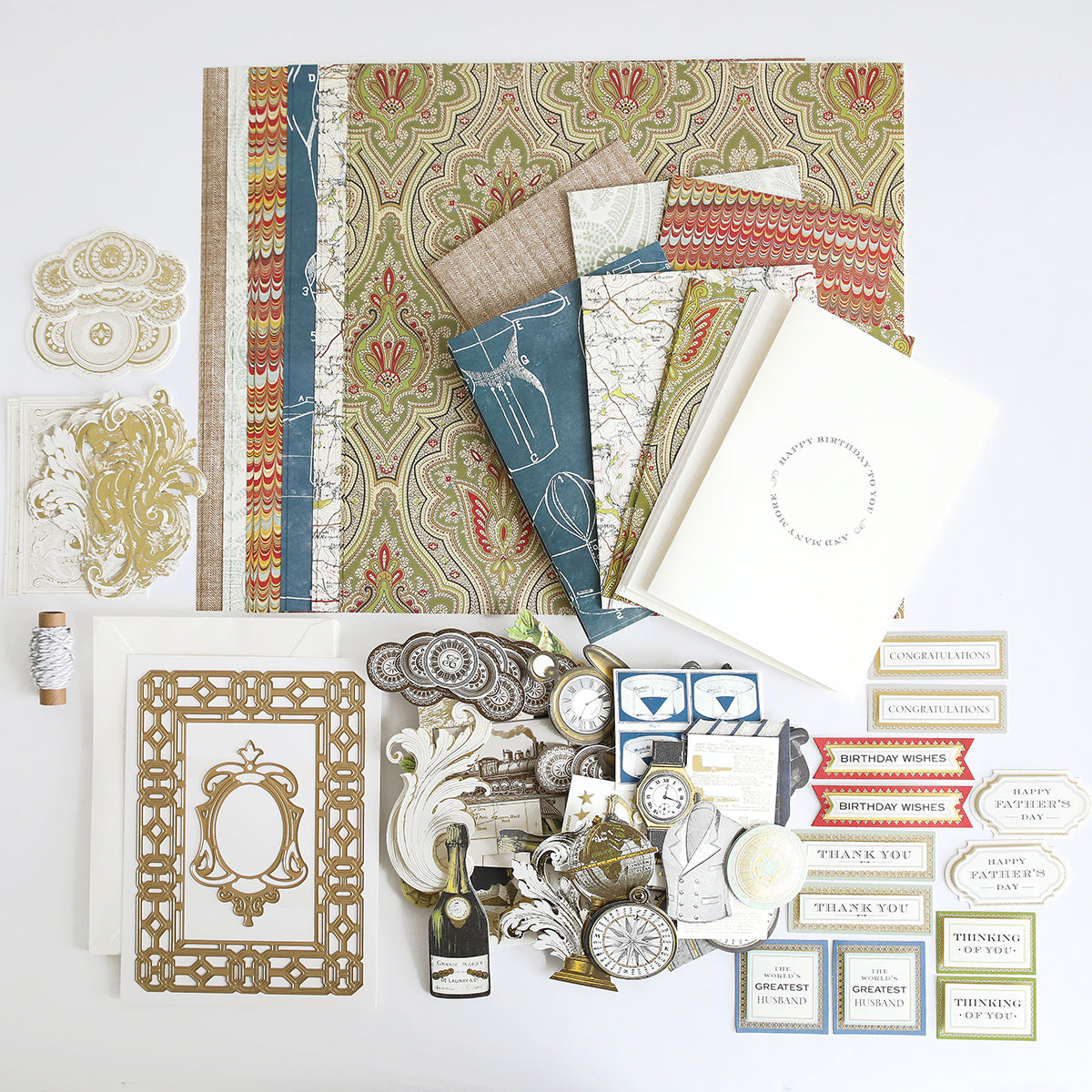 The All About Him Papercrafting Kit with Dies features patterned papers, blank cards, frames, tags, labels, and vintage embellishments for card making or scrapbooking—beautifully arranged on a white surface.