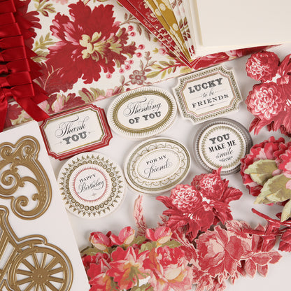 Greeting cards with assorted floral patterns, gold embellishments, and message labels like “Thank you” and “Happy Birthday,” crafted using vintage-inspired techniques and decorative dies from the Fleur Rouge Papercrafting Kit with Dies, displayed on a flat surface.