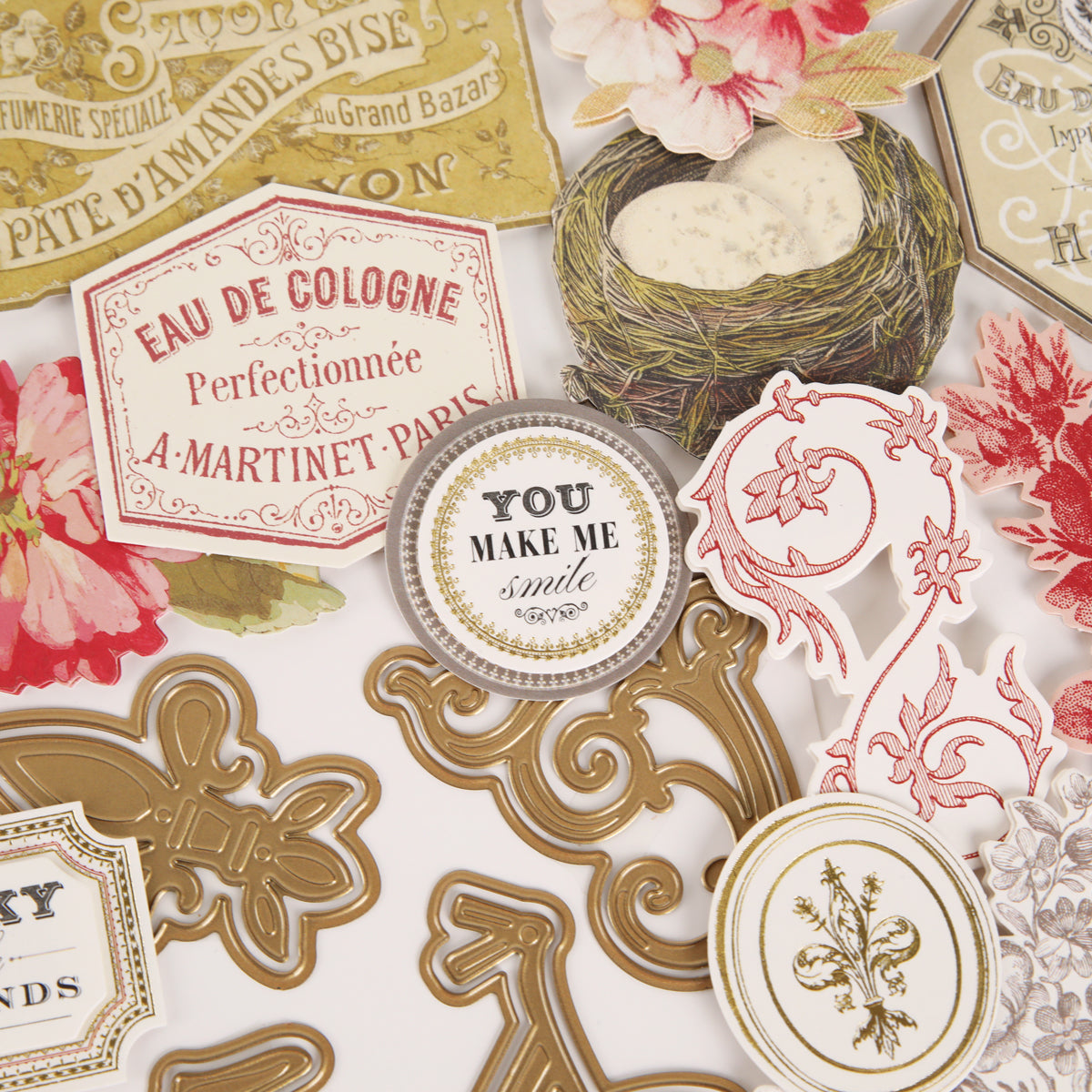 A set of ornate, vintage-style paper cutouts featuring floral motifs, gold scrolls, and beautifully lettered labels such as “You make me smile” and “Eau de Cologne,” perfect for vintage-inspired papercrafting. Designed for use with decorative dies or as part of the Fleur Rouge Papercrafting Kit with Dies.