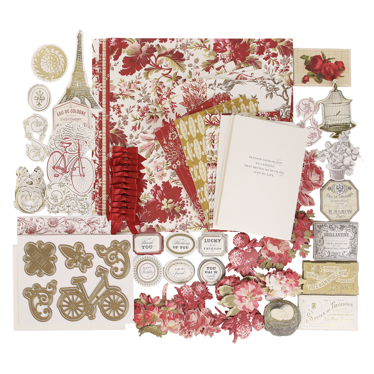 An assortment of vintage-inspired supplies from the Fleur Rouge Papercrafting Kit with Dies—featuring floral papers, cut-out shapes, an Eiffel Tower, bicycle, tags, cards, and a range of decorative dies and embellishments—arranged on a white background.