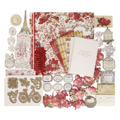 An assortment of vintage-inspired supplies from the Fleur Rouge Papercrafting Kit with Dies—featuring floral papers, cut-out shapes, an Eiffel Tower, bicycle, tags, cards, and a range of decorative dies and embellishments—arranged on a white background.