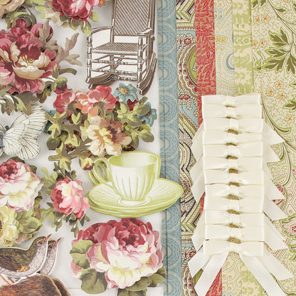 Haven Papercrafting Kit with Dies including floral, bird, teacup, and rocking chair coordinating dies, patterned paper sheets, and a strip of white satin bows.