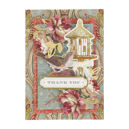 Handmade greeting card featuring a bird, a gold birdhouse, and floral accents over a patterned paisley background with a “Thank You” label, created using the Haven Papercrafting Kit with Dies.