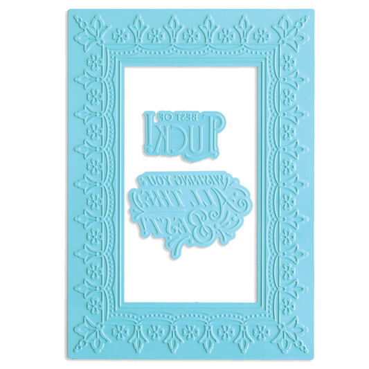 The Lucky Gilded Hot Foil Frame & Sentiment Plates is a light blue, rectangular plastic stencil with an ornate gold frame border and two reversed phrases: "BEST OF LUCK!" and "WE’RE ALL THINKING ABOUT YOU.