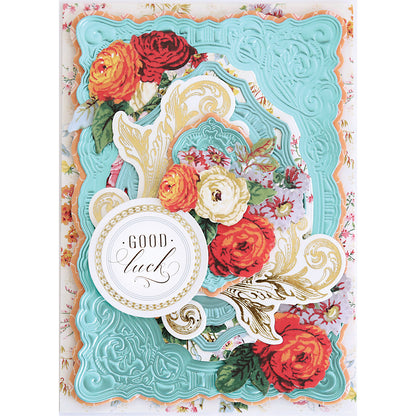 A decorative card featuring ornate turquoise embossing, gold accents, red and yellow flowers, and a "Good luck" label, beautifully highlighted using the Scroll Corner Concentric Frames 3D Die Set.
