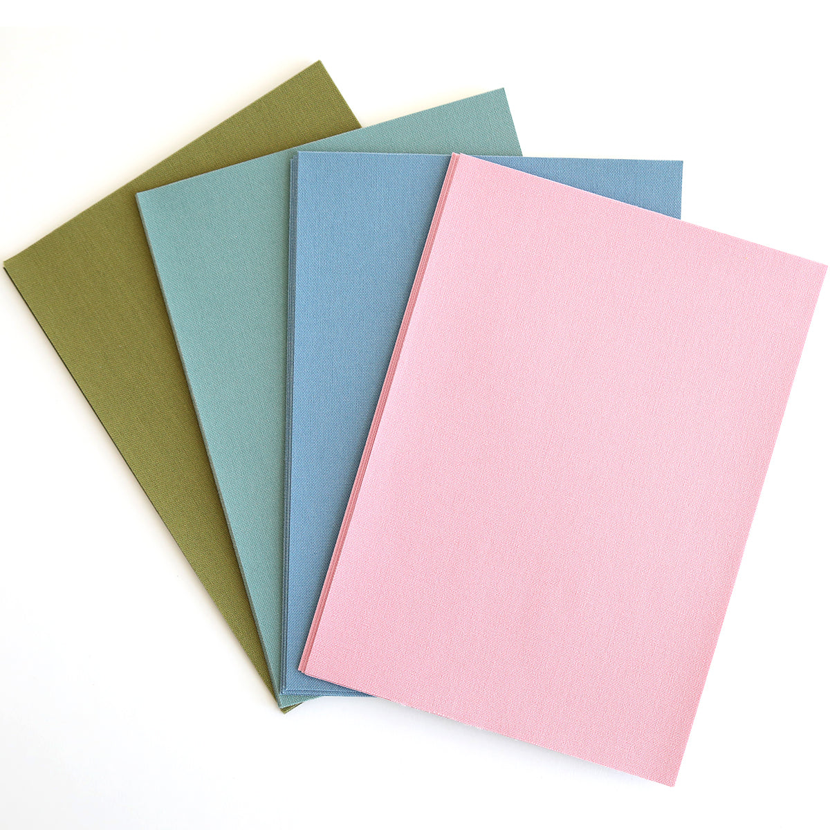 Four closed Fabric Card Layers Antique in olive green, teal, blue, and pink are fanned out on a white surface—perfect for inspiring your next card design or paper crafting project.