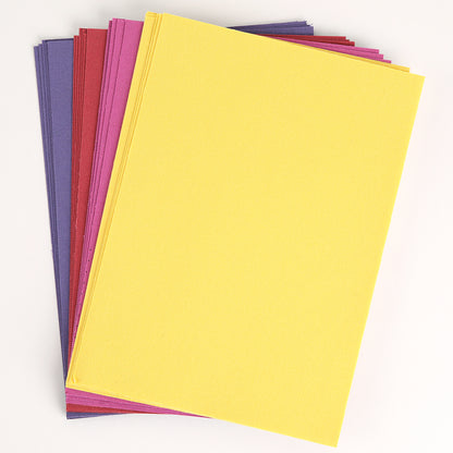 A stack of rectangular Bright Fabric Card Layers in yellow, purple, pink, and red is arranged on a white background—perfect for scrapbooking or card making.