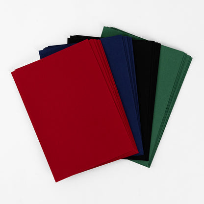Four stacks of Dark Fabric Card Layers—red, blue, black, and green—arranged in a fan on white, perfect for card making or layering projects.