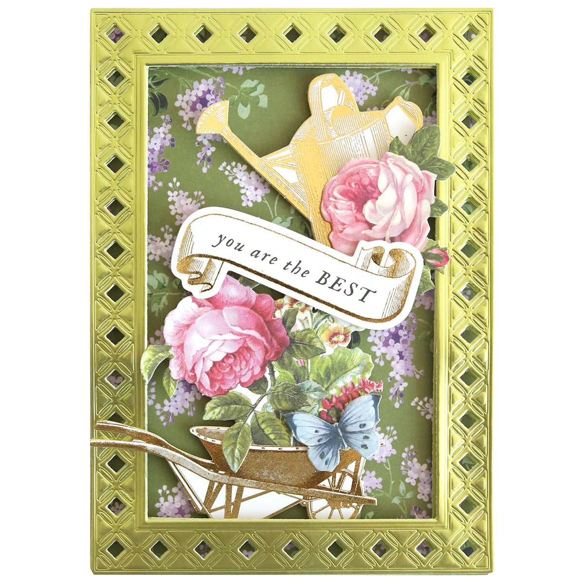 The In The Garden Ultimate Paper Crafting Kit includes a decorative card for cardmaking with pink roses, a butterfly, a gold watering can, and wheelbarrow framed in gold, plus "you are the BEST" text in the center.