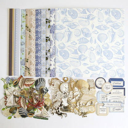 Summer House Cardstock and Embellishments featuring nautical and seashell designs, arranged on a white surface—perfect for coastal scrapbooking or nautical-themed crafts.