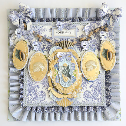 The Summer House Cardstock and Embellishments set creates a decorative collage with ornate frames, seashells, blue and white patterned paper, nautical accents, and a central "OUR story" sign.