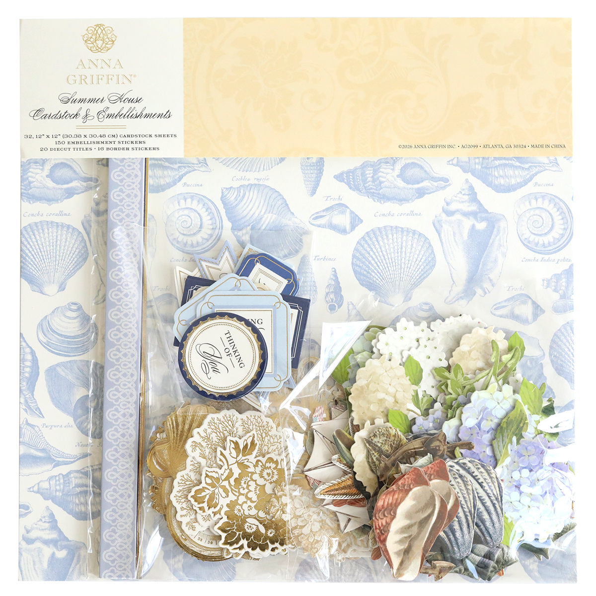 The Summer House Cardstock and Embellishments set includes blue seashell patterned paper, floral cutouts, tags, and nautical accents—ideal for coastal scrapbooking projects—all presented in attractive packaging.