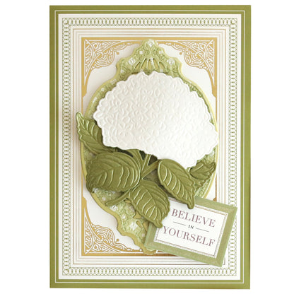 A decorative card on Luxury Ivory Soft Matte 250gsm Cardstock features an embossed white flower with green leaves and border, plus a “BELIEVE IN YOURSELF” sign in the lower right corner.