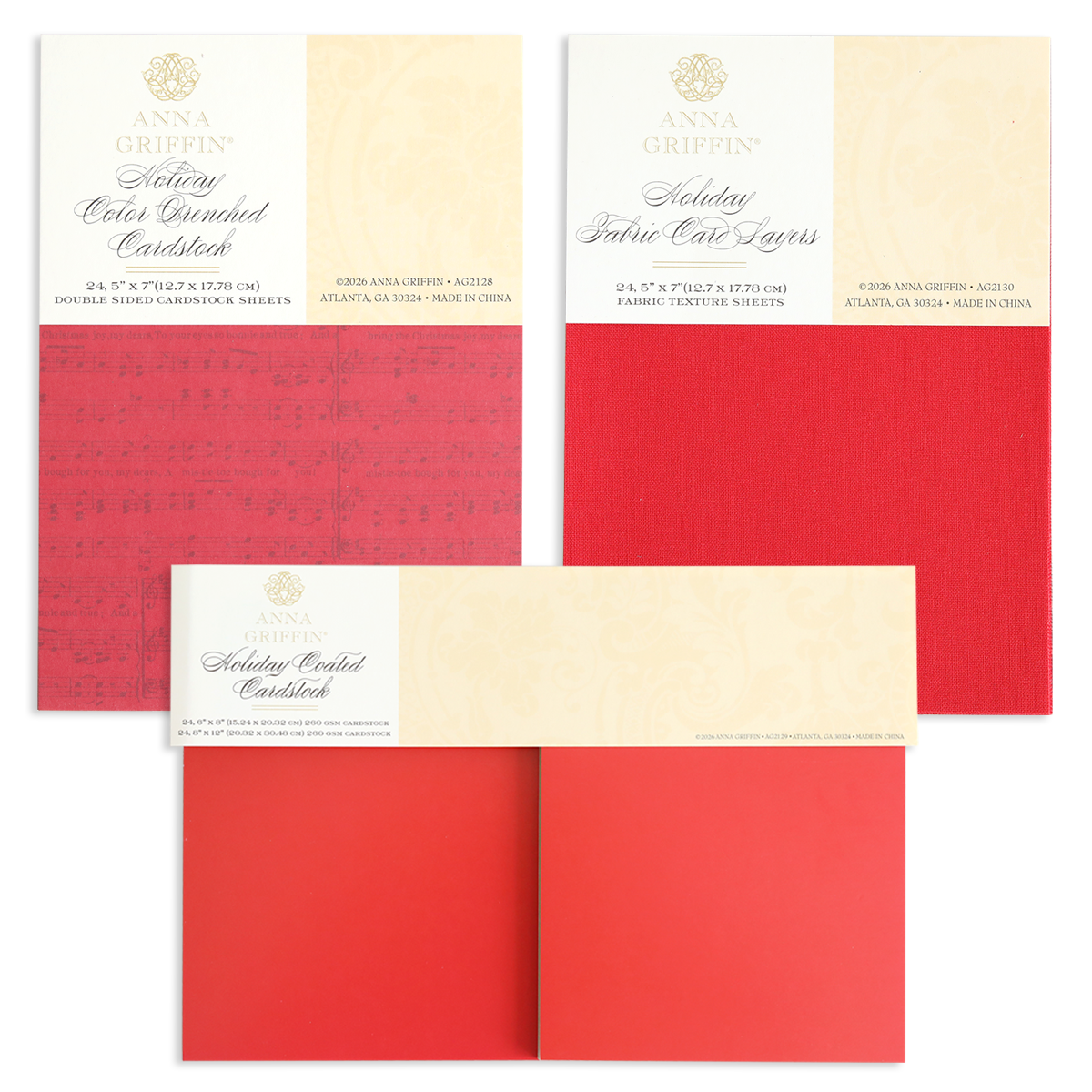 Three packs of the Holiday Cardstock Bundle by Anna Griffin, featuring textured layers in festive red shades—ideal for Christmas card making or adding cheer to your scrapbook paper crafts—are displayed flat with product labels visible at the top of each pack.