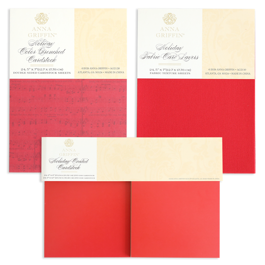 Three packs of the Holiday Cardstock Bundle by Anna Griffin, featuring textured layers in festive red shades—ideal for Christmas card making or adding cheer to your scrapbook paper crafts—are displayed flat with product labels visible at the top of each pack.