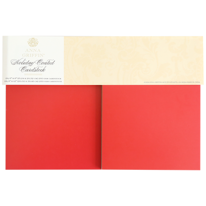 A pack of Holiday Coated Cardstock, ideal for foil holiday projects, with two large sheets of heavyweight red cardstock partially visible beneath the label.