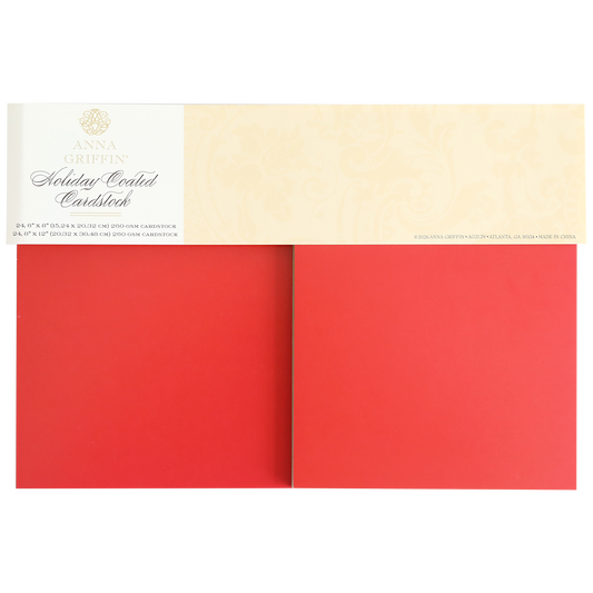 A pack of Holiday Coated Cardstock, ideal for foil holiday projects, with two large sheets of heavyweight red cardstock partially visible beneath the label.