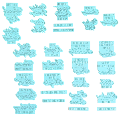 The Set of 30 Gilded Small Sentiment Plates features light blue, mirrored plastic stamps with a variety of short sympathy and birthday sentiments arranged in rows on a white surface—ideal for pairing with Small Sentiment Hot Foil Plates.