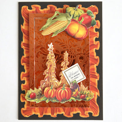 The Perfect Palette Fall Foil is a decorative autumn-themed card, ideal for autumn paper crafting and handmade cards, featuring embossed orange foil with corn, pumpkins, squash, fruit designs, and a small note that reads “Blessed to know you.”.