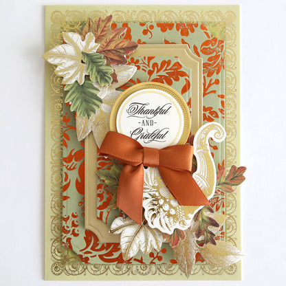 The Perfect Palette Fall Foil features gold and orange patterns with autumn leaves, a brown bow, and the message “Thankful and Grateful” in the center—ideal for handmade cards or autumn-themed paper crafting projects.