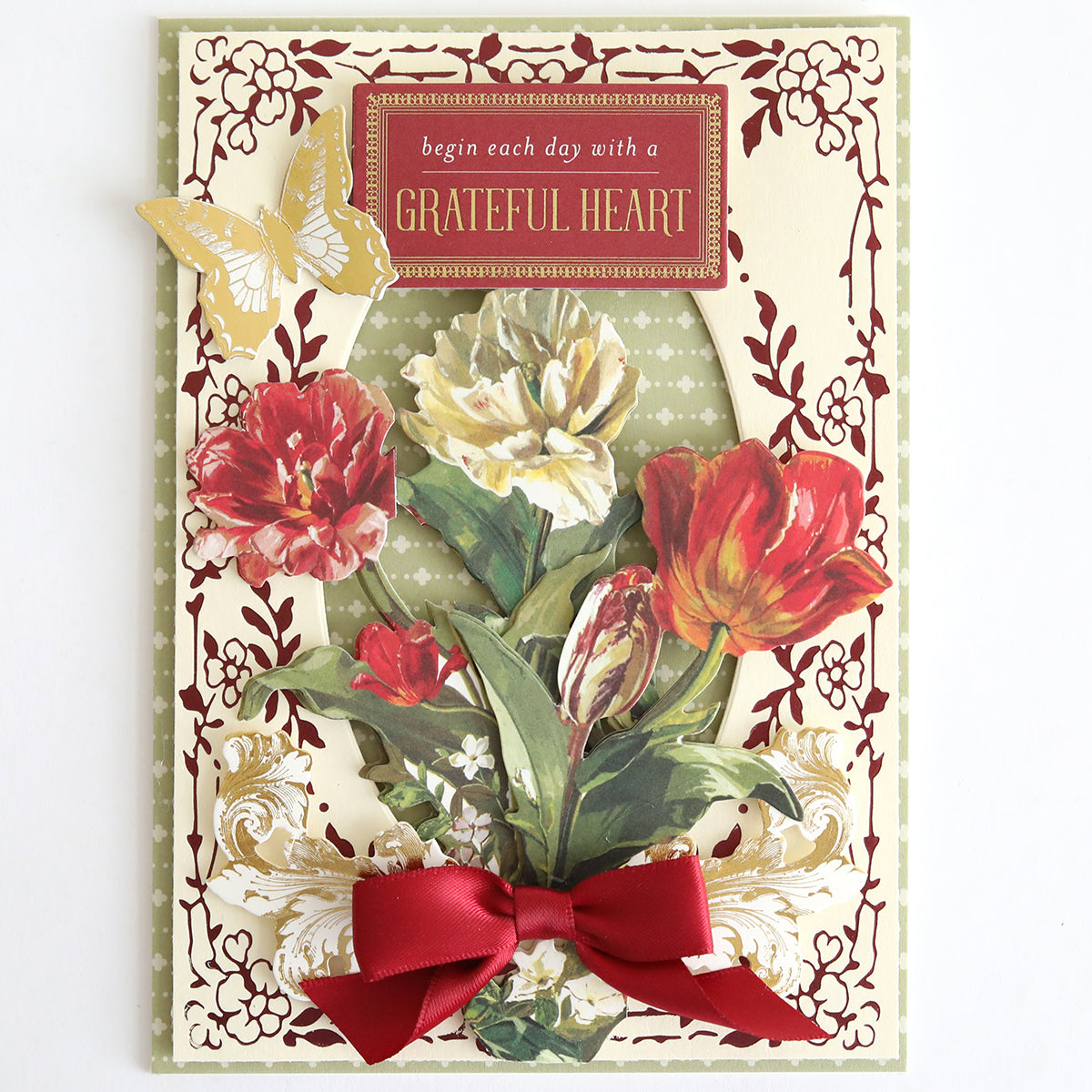 Perfect Palette Fall Foil features a beautiful design with red and yellow flowers, a red ribbon, a butterfly, and the sentiment “begin each day with a GRATEFUL HEART” on an ornate cream and green background—ideal for creating handmade cards or autumn-themed paper crafting projects.