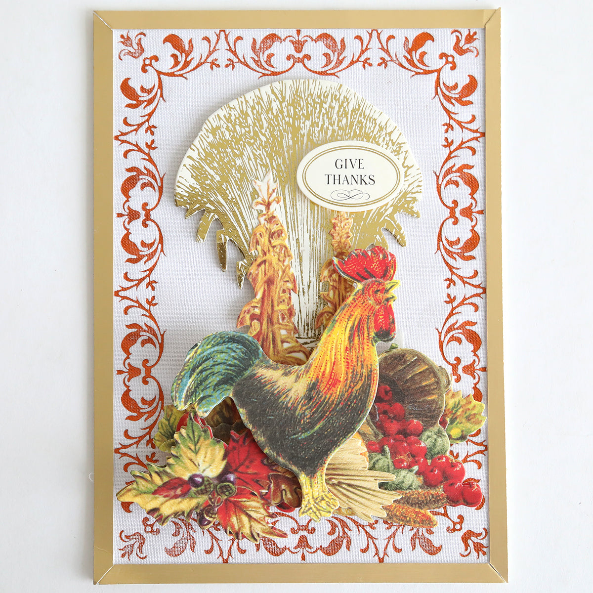 Brighten your autumn paper crafting projects or handmade card collection with Perfect Palette Fall Foil—a decorative card showcasing a rooster, harvest produce, and wheat sheaves beneath a “Give Thanks” sign, all elegantly bordered by an ornate orange and gold frame.