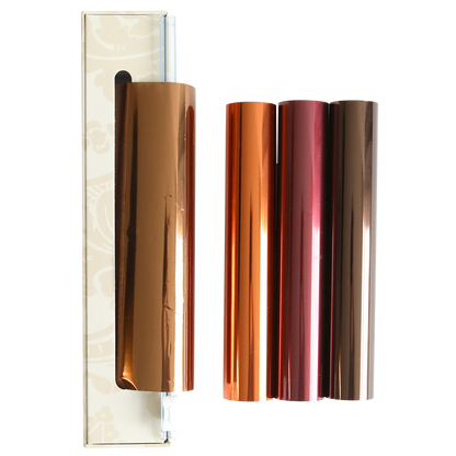 Four rolls from the Perfect Palette Fall Foil set—in copper, orange, rose gold, and bronze—are displayed next to a box on a white background, making them ideal for autumn paper crafting and adding a luxurious touch to handmade cards.