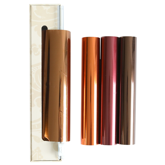 Four rolls from the Perfect Palette Fall Foil set—in copper, orange, rose gold, and bronze—are displayed next to a box on a white background, making them ideal for autumn paper crafting and adding a luxurious touch to handmade cards.