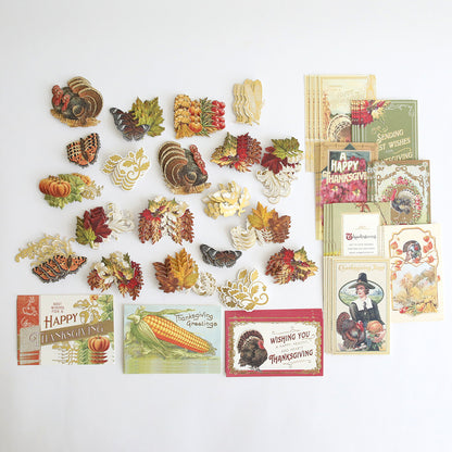 The Fall Thanksgiving Postcards and Embellishments set features vintage-style postcards, paper turkeys, pumpkins, and autumn leaves arranged on a white background for a charming collection of autumn paper crafts and fall décor.