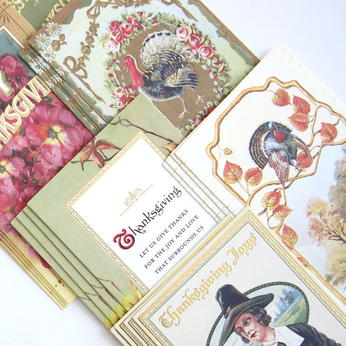 The Fall Thanksgiving Postcards and Embellishments set showcases vintage designs with turkeys, florals, and a Pilgrim, artfully layered on a white background—ideal for autumn paper crafts or as delightful fall-themed accents.