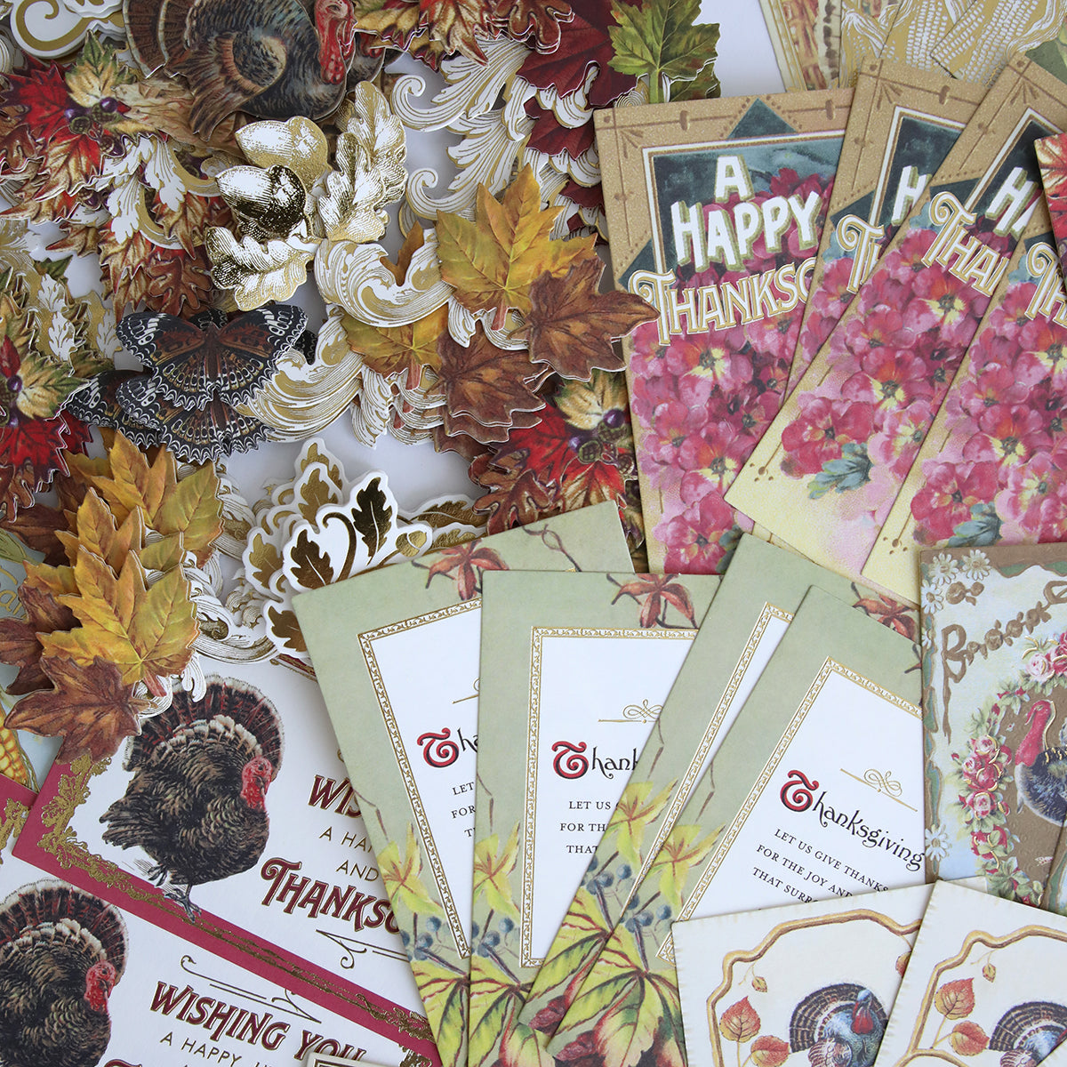 The Fall Thanksgiving Postcards and Embellishments, featuring turkey motifs, autumn leaves, and floral designs, are displayed in a vibrant, overlapping arrangement.