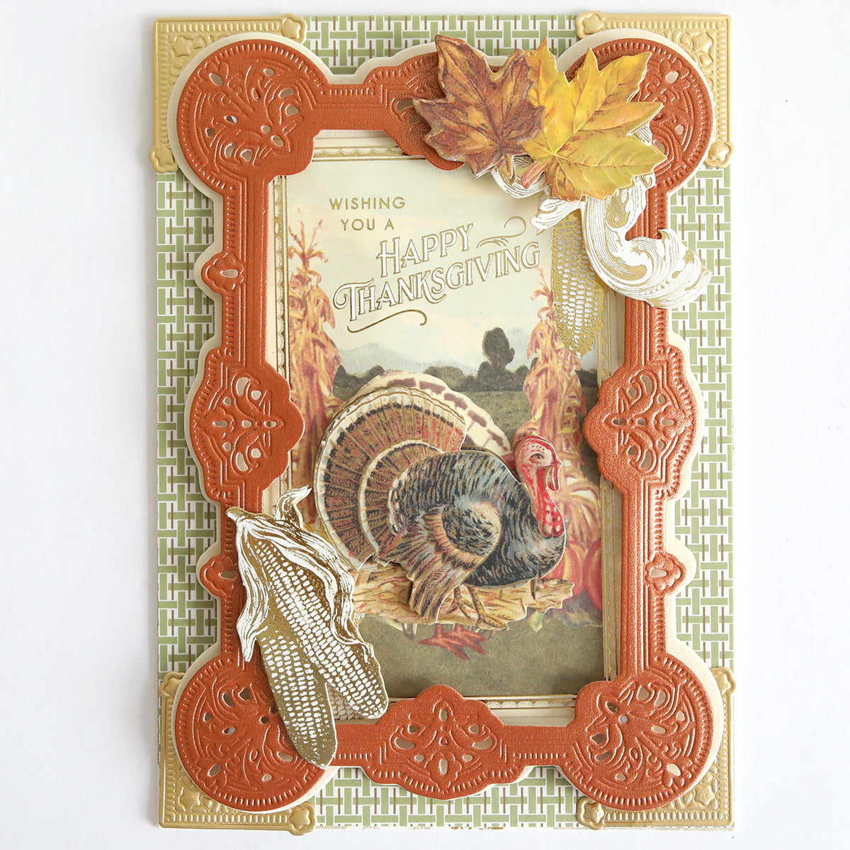 Introducing the Fall Thanksgiving Postcards and Embellishments: Each postcard features an illustration of a turkey surrounded by autumn leaves and corn, elegantly framed with ornate orange and gold borders. Ideal for autumn paper craft enthusiasts, these postcards are adorned with the warm message, “Wishing you a Happy Thanksgiving.”.